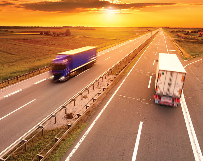 Trucks on Highway at Sunset