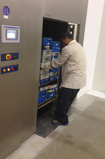 Stephen Foster, UPS Loaner Inbound Lead, moves medical devices out of autoclave, a decontamination process that uses steam heated at 300 degrees.