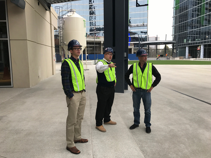 Atlanta Braves Assistant Director of Premium Sales Nick Nicastro points out some of the details concerning the ongoing construction of SunTrust Park to Conway executives Charles FitzGibbon and Adam Jones-Kelley.