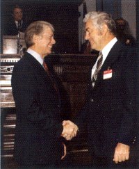 Conway (right) shakes hands with President Jimmy Carter. Carter